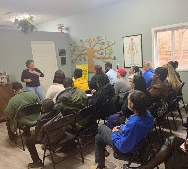 A member teaching a workshop to a seated room
