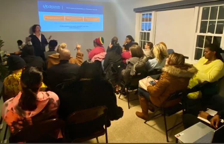 A workshop in a full room, attendees engaged