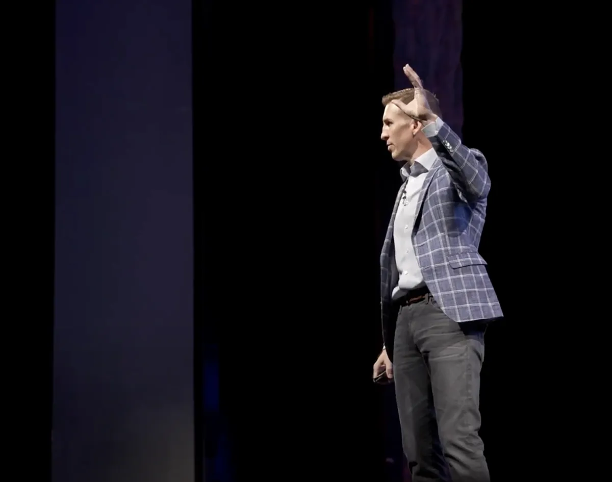 Dr. Steve Tullius delivering a keynote on a main stage